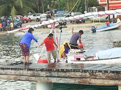 Selling fresh seafood at the pier in Placencia, Belize