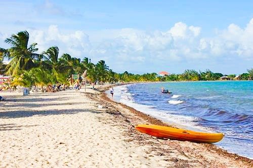 White sand beach with a kayak in Placencia, Belize