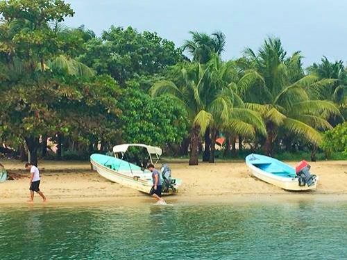 Beach with boats in Placencia, Belize