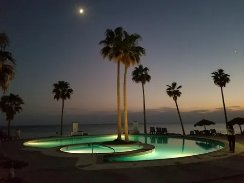 illuminated pool at night at Casa Blanca Golf Villas