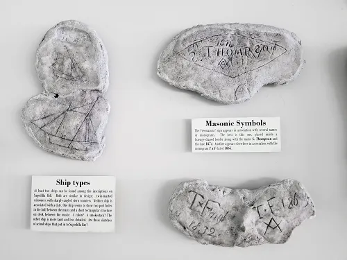 Rock Carvings from Sapodilla Hill displayed in the Check-in Hall at the Providenciales airport in Providenciales, Turks and Caicos Islands