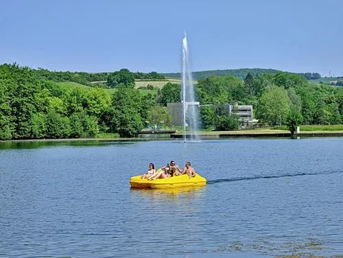 A yellow boat and fountain in Lake Echternach in Luxembourg