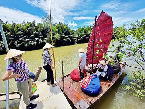 boarding a sampan for a Mekong Delta cruise in Vietnam