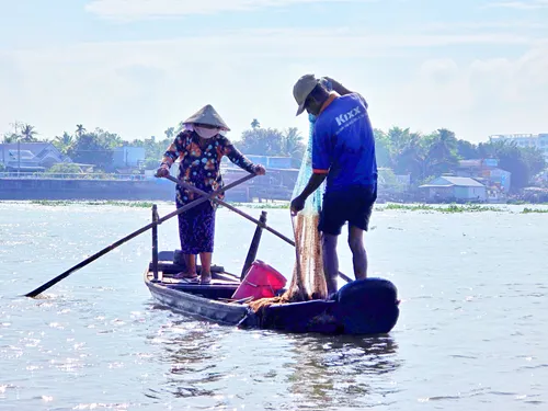 two fishermen on the Mekong River in Vietnam