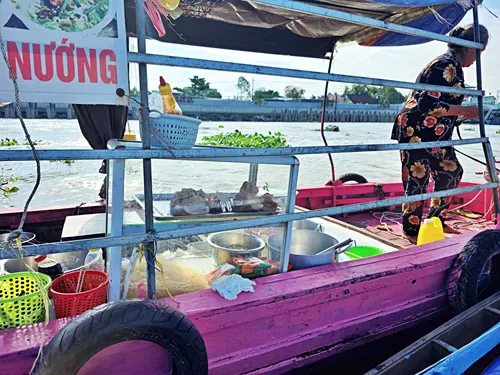 one of the many boats that sell food to participants and visitors of Cái Răng Floating Market near Can Tho in Vietnam