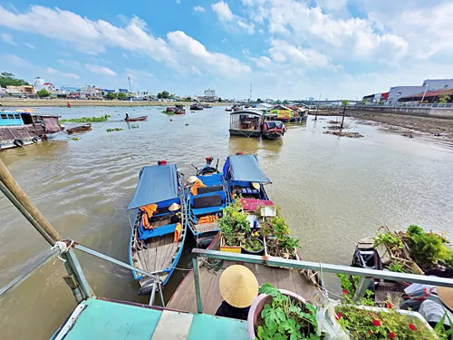 View from a large ship at other ships and small boats of the Cái Răng Floating Market near Can Tho in Vietnam