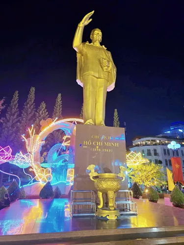 golden Ho Chi Minh statue beautifully illuminated at night at the Can Tho waterfront promenade in Can Tho in Vietnam