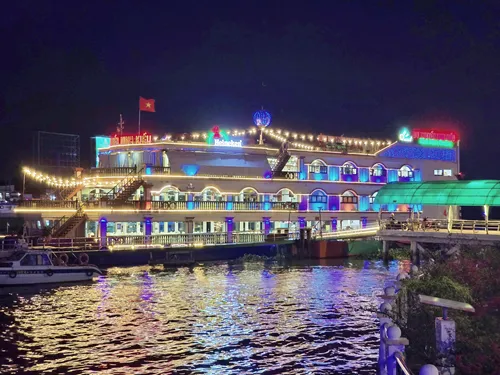 beautifully illuminated river cruise ship at night at the Can Tho waterfront promenade in Can Tho in Vietnam