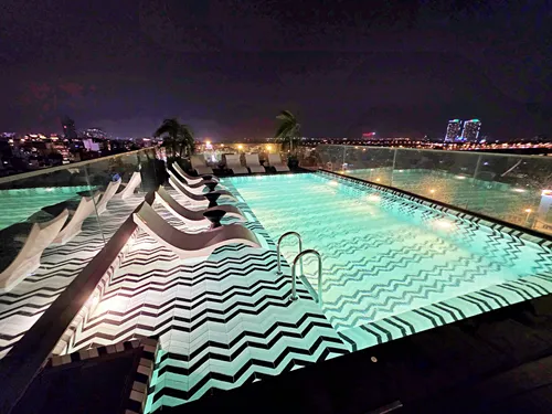 photo of the illuminated roof-top pool at night at CLASSYC Hotel, Hanoi in Vietnam
