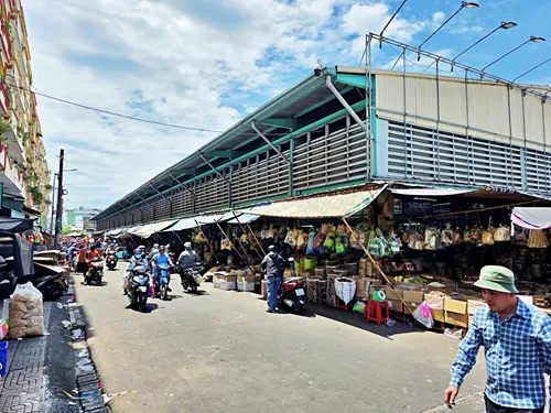 interior of Binh Tay Market in Ho Chi Minh City in Vietnam with stairs and many stores and people