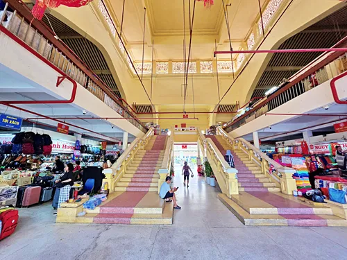 interior of Binh Tay Market in Ho Chi Minh City in Vietnam with stairs and many stores and people