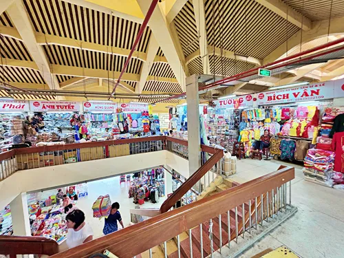 view of the inside of Binh Tay Market in Ho Chi Minh City, Vietnam, from the upper floor, showing many stores and people shopping