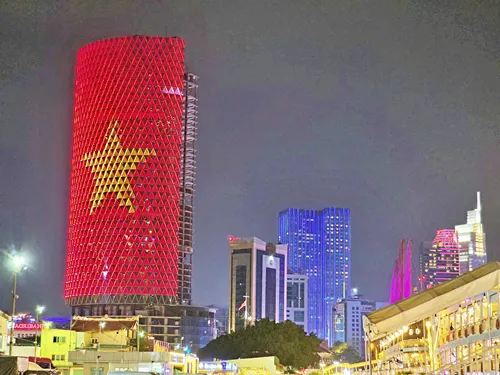 Beautifully illuminated Ho Chi Minh City skyline at night during a Saigon River Dinner Cruise in Vietnam