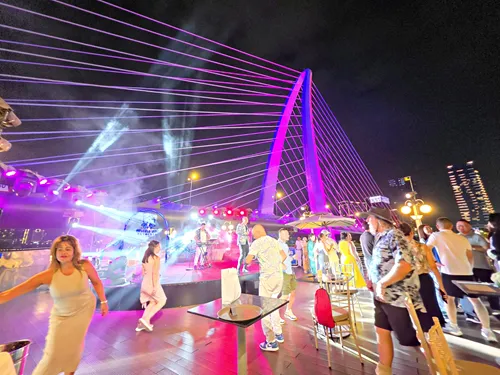 party on a Saigon River Dinner Cruise in Vietnam and Beautifully illuminated Ho Chi Minh City skyline