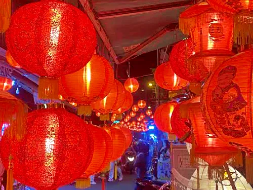 photo of many colorful lanterns at night at Luong Nhu Hoc Lantern Street in Ho CHi Minh City in Vietnam