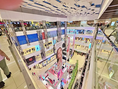 photo taken on the 5th floor of of Saigon Centre in Ho Chin Minh City, Vietnam, shwoing luxurious stores, beautiful decorations, and many shoppers
