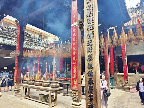 photo of smoking incense inside Thien Hau Temple in Ho Chi Minh City in Vietnam