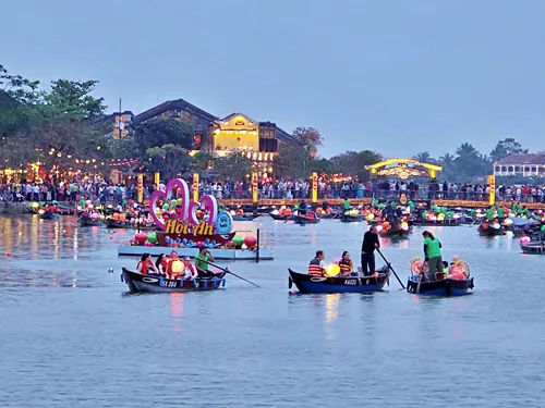 photo taken of the river, lantern boats, and the illuminated houses furing the Hoi An Lantern Festival in Hoi An in Vietnam