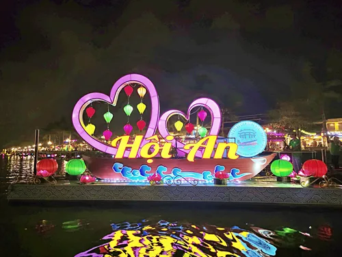photo taken of the river, lantern boats, and the illuminated houses furing the Hoi An Lantern Festival in Hoi An in Vietnam