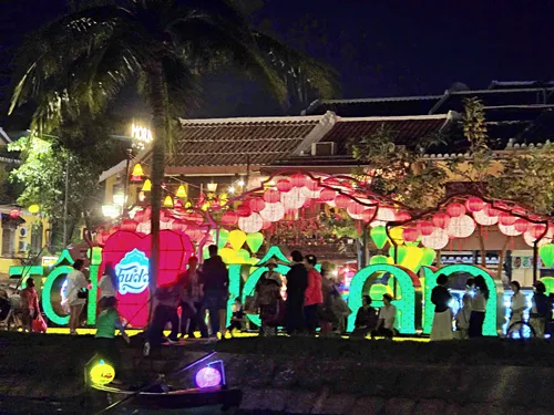 photo of buildings illuminated at night with many beautiful colorful lanterns during the Hoi An Lantern Festival in Vietnam
