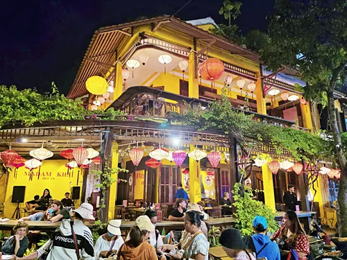 photo of buildings illuminated at night with many beautiful colorful lanterns during the Hoi An Lantern Festival in Vietnam
