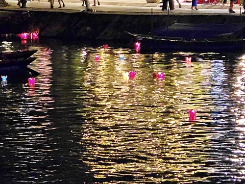 river with boats and many colorful paper lanterns on the river at night during the Hoi An Lantern Festival in Vietnam